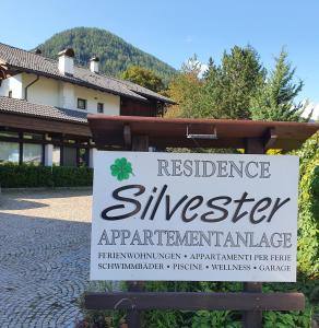 a sign in front of a building with a residence siglerarmaarmaarmaarma at Residence Silvester in Racines