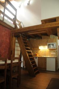 a kitchen with a wooden staircase in a room at EL VASALLO in Tragacete