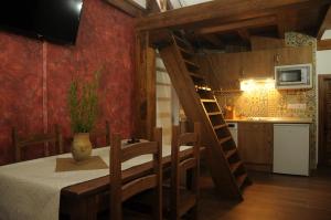 a kitchen and dining room with a table and a ladder at EL VASALLO in Tragacete