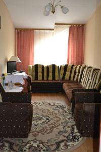a living room with a couch and chairs and a table at Zajazd Maxim in Żywiec +7 photos
