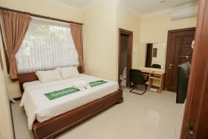 Voodi või voodid majutusasutuse Ubud Hotel & Cottages toas