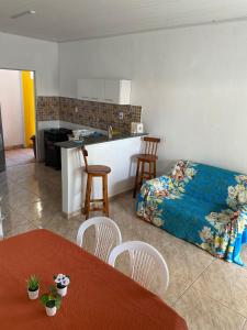 a living room with a bed and a kitchen at Casa Frida Aracaju a 500m da praia in Aracaju