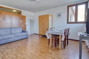 a living room with a table and a couch at 200m pistes - Appartement 4 personnes - Adervielle in Val Louron +20 photos