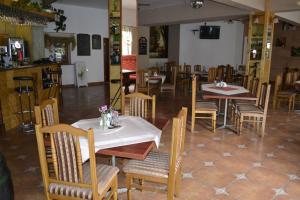 a dining room with tables and chairs in a restaurant at Zajazd Maxim in Żywiec