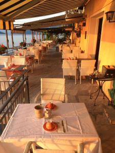 a row of tables and chairs at a restaurant at Art Hotel Ristorante Posta Al Lago in Ronco sopra Ascona