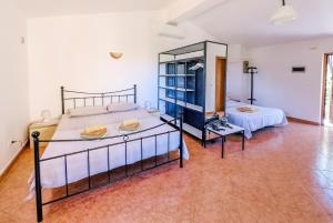 a large room with two beds and a table at Studio Apartment Gianni in Vižinada