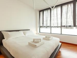 Posteľ alebo postele v izbe v ubytovaní easyhomes-Madonnina View