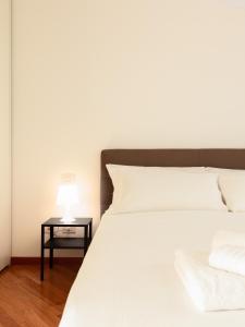 Posteľ alebo postele v izbe v ubytovaní easyhomes-Madonnina View