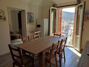 a dining room table with chairs and a large window at Centralissima Favignana in Favignana