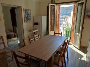 a dining room with a wooden table and chairs at Centralissima Favignana in Favignana