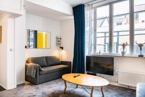 a living room with a couch and a tv at The Brewer Atelier by Daniel&Jacob's in Copenhagen