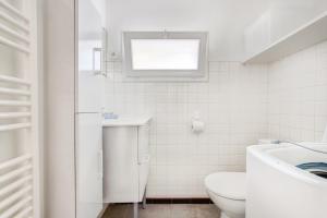 a white bathroom with a toilet and a sink at Séjour détente à Bretignolles-sur-Mer pour 5 personnes in Brétignolles-sur-Mer +21 photos