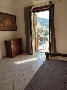 a bedroom with a bed and a sliding glass door at Centralissima Favignana in Favignana