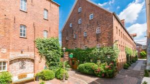 an alleyway between two large red brick buildings at Romantik Hotel Reichshof in Norden