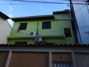 a green building with windows on the side of it at Brasil mulato in Salvador