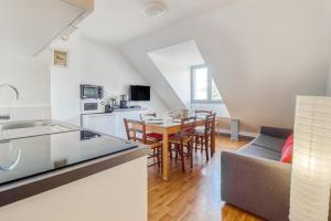 a kitchen and living room with a table and a couch at Belle Sayette - À 200m des pistes - pour 8 personnes in Val Louron +45 photos