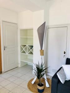 uma sala de estar com uma planta num vaso ao lado de uma porta em Maison avec terrasse à 50 m de la mer em Pornic