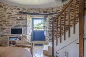 a living room with a staircase and a blue door at Nuit insolite sur la presqu'île de Rhuys in Sarzeau