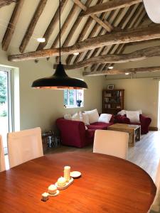 a living room with a table and a couch at Lower Farm Lodge in Stowmarket