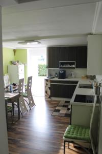 a kitchen with a table and chairs and a kitchen with a counter at Zimmer Steger in Gnas