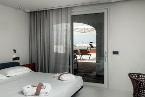 a hotel room with a bed and a balcony at Le 3 di Tuccino in Polignano a Mare