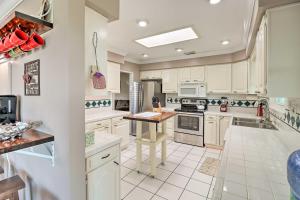 a kitchen with white cabinets and a table in it at Robinson Roost Retreat Less Than 2 Mi to Norfork Lake in Mountain Home