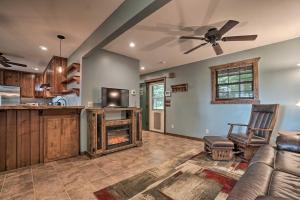 a living room with a couch and a ceiling fan at Yellow Mountain Blairsville Cabin with Scenic Deck in Hood