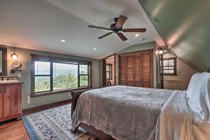 a bedroom with a bed and a ceiling fan at Yellow Mountain Blairsville Cabin with Scenic Deck in Hood