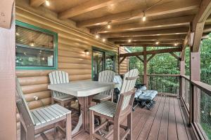a wooden deck with a table and chairs on it at Yellow Mountain Blairsville Cabin with Scenic Deck in Hood +18 photos