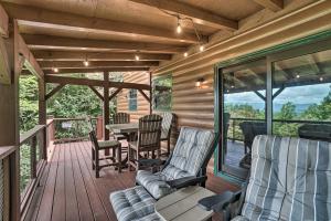 a porch with chairs and a table on a deck at Yellow Mountain Blairsville Cabin with Scenic Deck in Hood