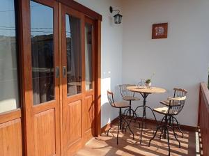 un patio con mesa y sillas junto a una puerta en Residencia Sao Miguel en Tiradentes