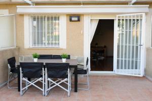 a table and chairs in front of a house at Chalet Coral Denia in Denia