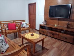 a living room with a flat screen tv at Residencia Sao Miguel in Tiradentes