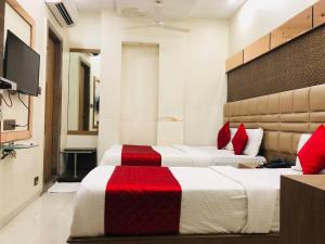 Postel nebo postele na pokoji v ubytování Hotel Guestinn Residency