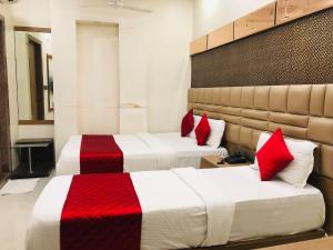 Postel nebo postele na pokoji v ubytování Hotel Guestinn Residency