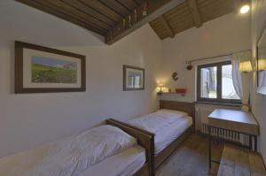 a bedroom with two beds and a window at Chesa Minouche - Celerina in Celerina