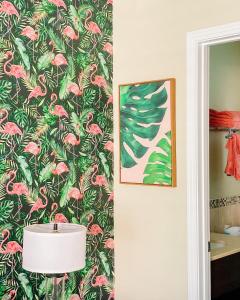 a bathroom with a wallpaper with pink flowers and a lamp at The Local - St. Augustine in St. Augustine +83 photos