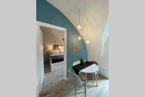 a room with a table and chairs and a bedroom at Casa Meraki - Apartment in Bergamo