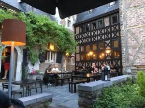 a group of people sitting at tables in a restaurant at La cave de Nana in Liège
