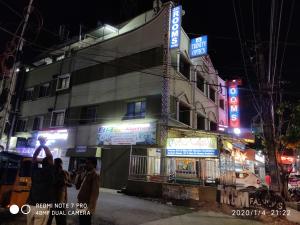 a building with neon signs on the side of it at S.S.K RESIDENCY in Chennai