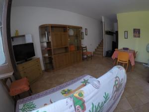 a living room with a couch and a television at RESIDENCE 3 STARs SAN VITO LO CAPO in San Vito lo Capo