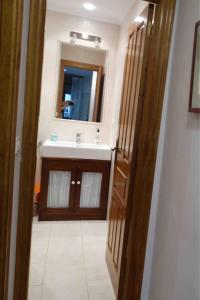 a bathroom with a sink and a mirror at El Herrador in Nájera