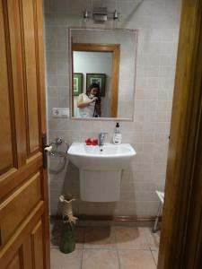 a woman taking a picture of a sink in a bathroom at El Herrador in Nájera