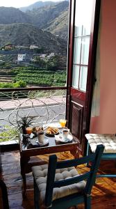a room with a table with food and a view at Apartamento Patricia in Hermigua
