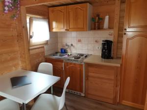 a kitchen with a table and a table and chairs at Kleine Auszeit in Waren