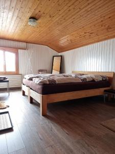a bedroom with a large bed with a wooden ceiling at Casa Leon in Vrin