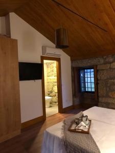 a bedroom with a bed with a sink in it at Quinta do Pinheiro in Guimarães