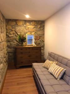 a living room with a couch and a dresser at Quinta do Pinheiro in Guimarães