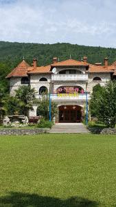 a large stone building with a green lawn in front of it at bungalo in Buzet