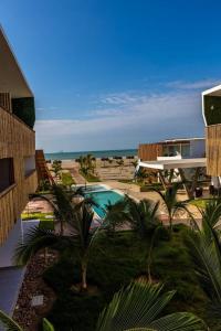 a resort with a swimming pool and a beach at Departamento Las Palmeras de Bocapan 308 in Tumbes